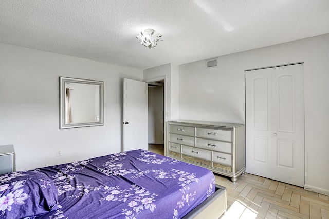 bedroom featuring a closet and a textured ceiling