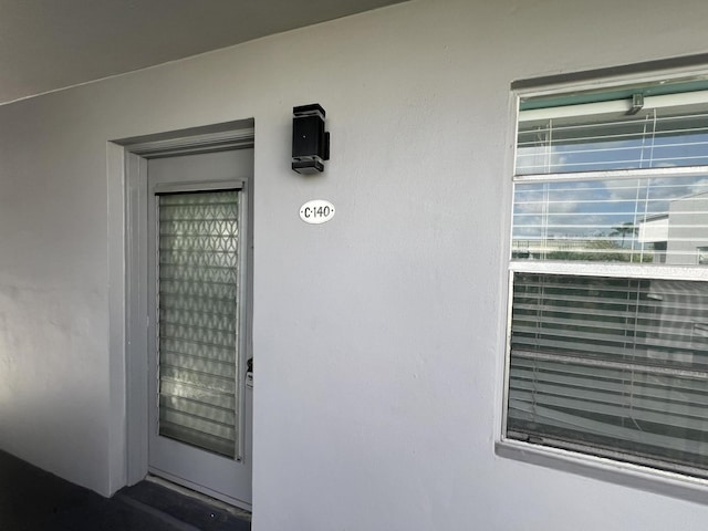 property entrance featuring stucco siding