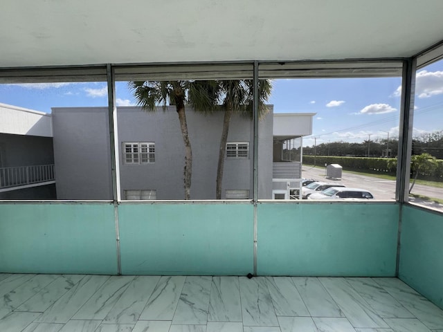 unfurnished sunroom with plenty of natural light