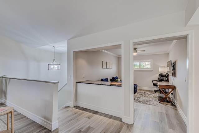 interior space featuring light hardwood / wood-style floors, hanging light fixtures, and ceiling fan