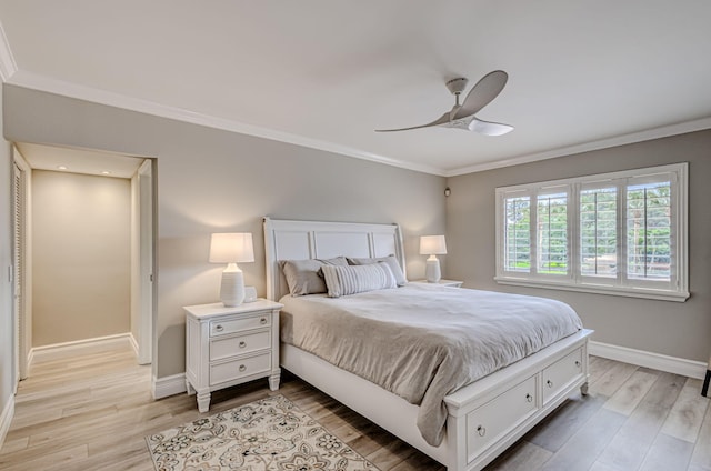 bedroom with crown molding, light hardwood / wood-style floors, and ceiling fan