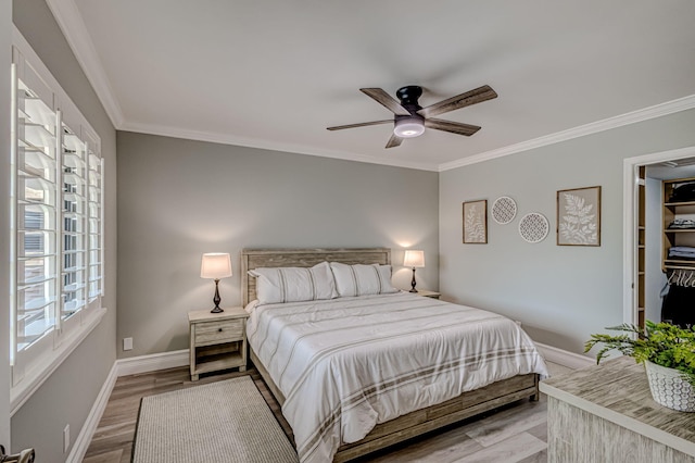 bedroom with ornamental molding, ceiling fan, and light wood-type flooring