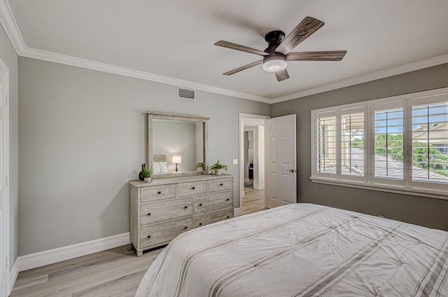 bedroom with ornamental molding, ceiling fan, and light hardwood / wood-style flooring