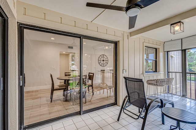 sunroom featuring ceiling fan