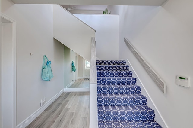 stairs with light wood-type flooring