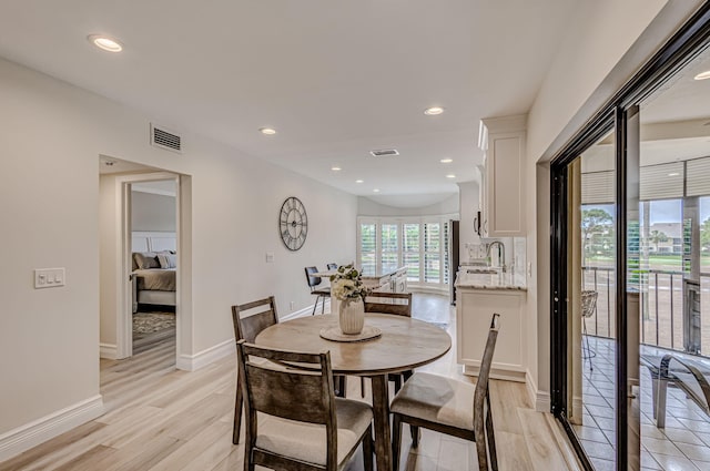 dining space featuring sink and light hardwood / wood-style flooring