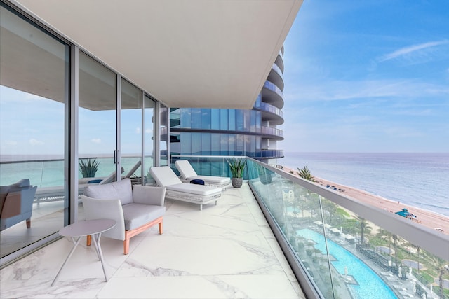 balcony with a water view and an outdoor hangout area