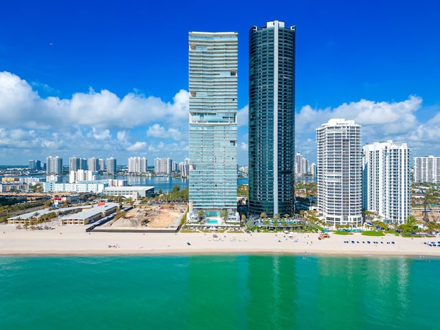 view of city with a water view and a beach view