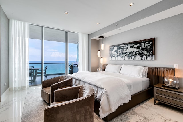 bedroom with a water view, access to exterior, floor to ceiling windows, and light tile floors