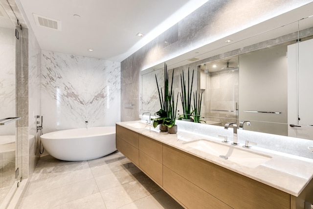 bathroom featuring independent shower and bath, tile walls, dual bowl vanity, and tile floors