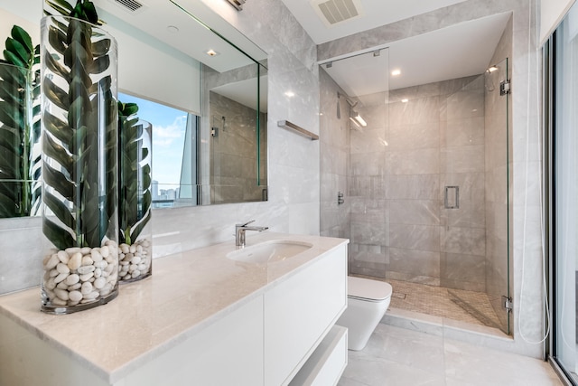 bathroom featuring an enclosed shower, tile walls, toilet, and vanity