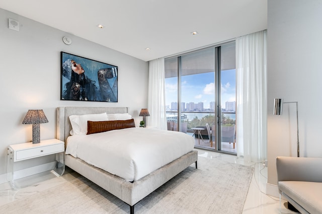 bedroom with a wall of windows, access to exterior, and light tile floors