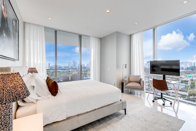 bedroom with a wall of windows and light tile floors