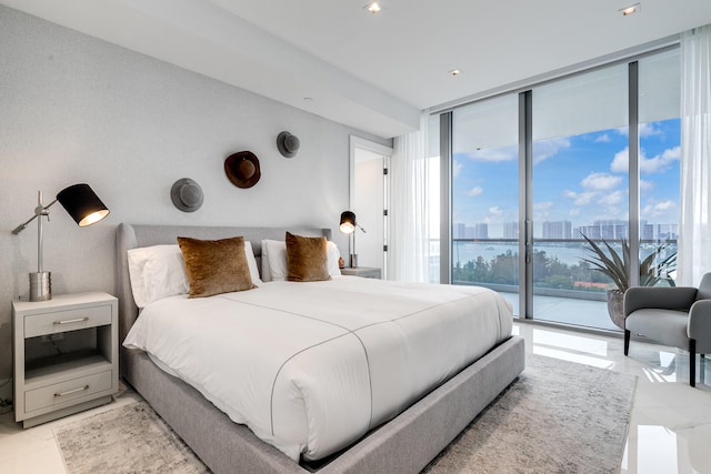 tiled bedroom with expansive windows, access to outside, and a water view