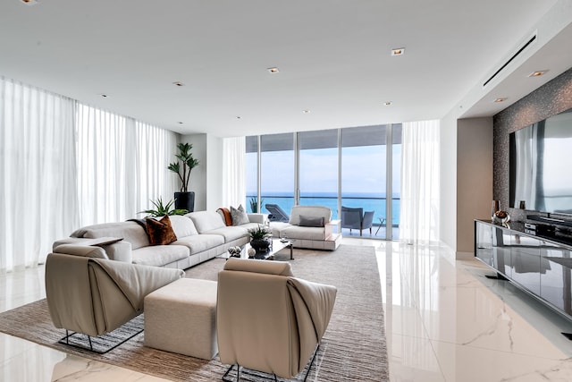 living room with a water view, expansive windows, and light tile floors