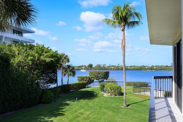 view of yard with a balcony and a water view