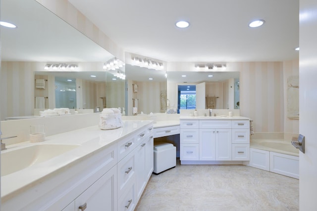 bathroom featuring oversized vanity, tile floors, and a bathtub