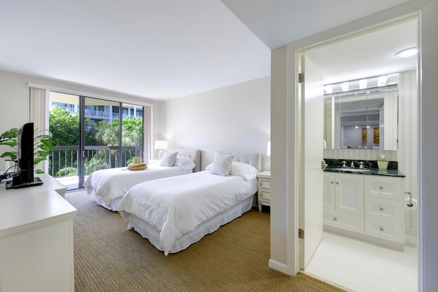 bedroom with carpet floors, access to exterior, and sink