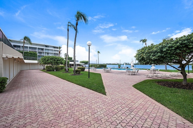 surrounding community with a pool and a lawn