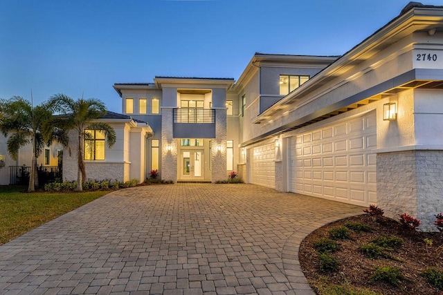 view of front of property with a balcony and a garage