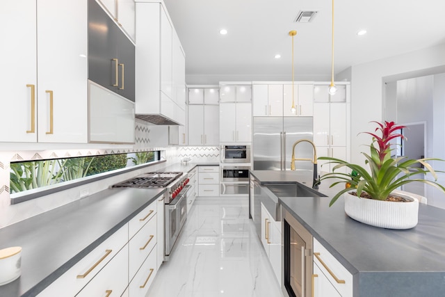 kitchen featuring sink, hanging light fixtures, backsplash, white cabinets, and high end appliances