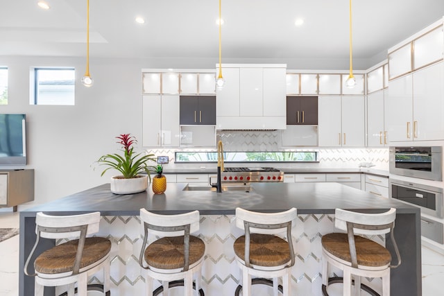 kitchen featuring white cabinetry, oven, and hanging light fixtures