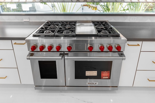 room details with range with two ovens and white cabinetry