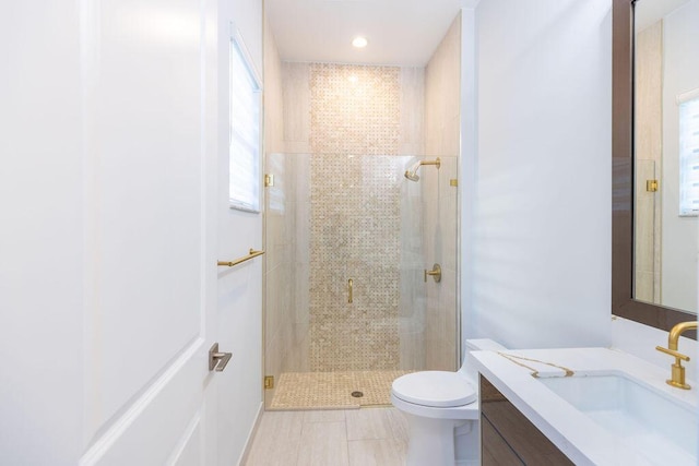 bathroom featuring walk in shower, vanity, and toilet