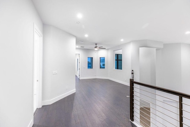 unfurnished room with ceiling fan and dark hardwood / wood-style flooring