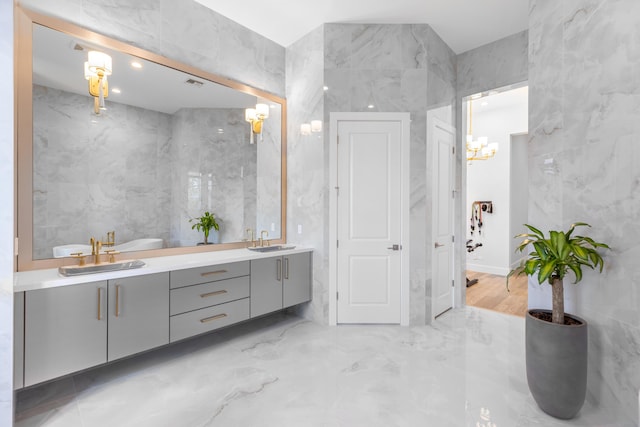 bathroom featuring vanity and tile walls