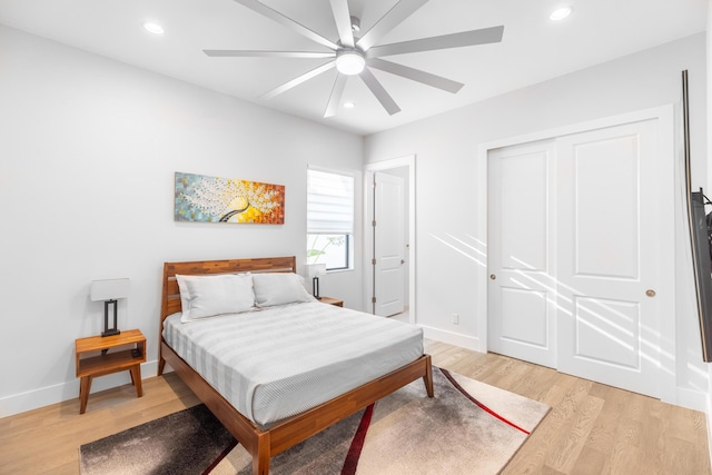 bedroom featuring light wood-type flooring, a closet, and ceiling fan