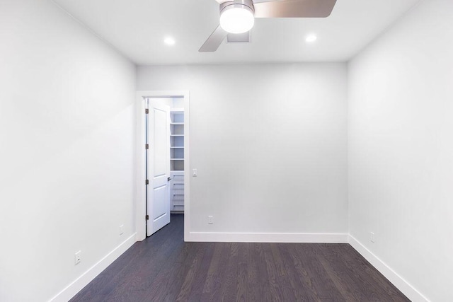 empty room featuring ceiling fan and dark hardwood / wood-style floors