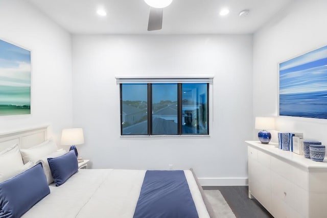 bedroom with dark hardwood / wood-style flooring and ceiling fan