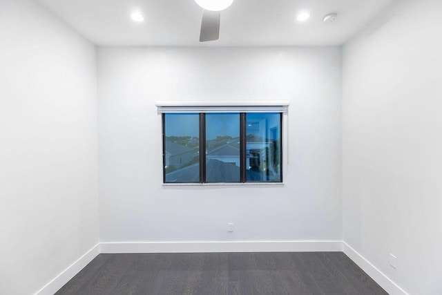 spare room with ceiling fan and dark wood-type flooring