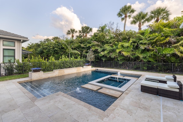 view of swimming pool featuring pool water feature, a patio area, and an in ground hot tub