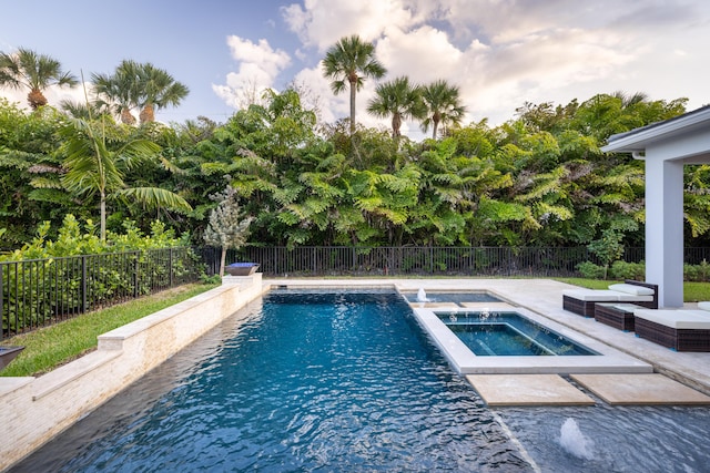 view of swimming pool with an in ground hot tub