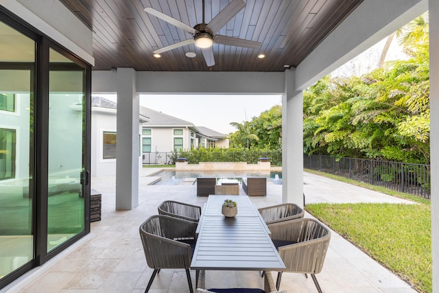 view of patio / terrace with a pool and ceiling fan