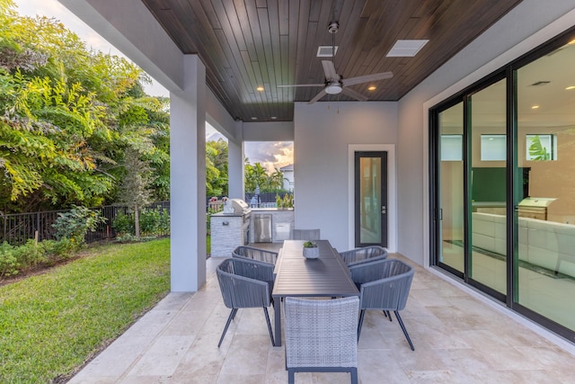 view of patio with ceiling fan and area for grilling