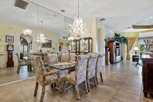 tiled dining area featuring a chandelier