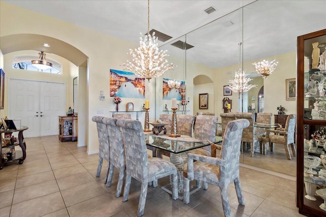 8839 Via Avellino, Lake Worth, FL 33467 - dining area with arched walkways, a chandelier, and light tile patterned floors