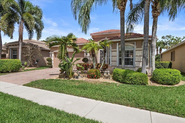 8839 Via Avellino, Lake Worth, FL 33467 - mediterranean / spanish-style home with stucco siding, a tiled roof, decorative driveway, a garage, and a front yard