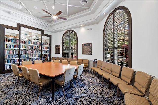 carpeted dining space featuring coffered ceiling, plenty of natural light, crown molding, and ceiling fan