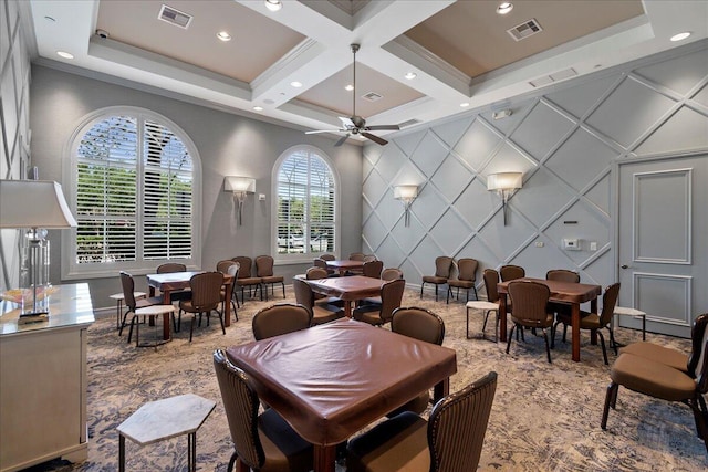 dining room featuring coffered ceiling, plenty of natural light, and ceiling fan