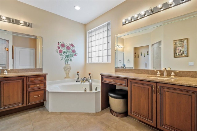 bathroom featuring vanity, tile floors, and a washtub