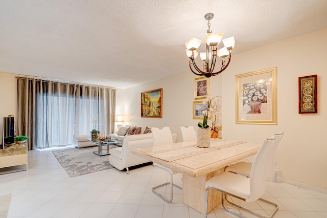 dining area with an inviting chandelier and a textured ceiling