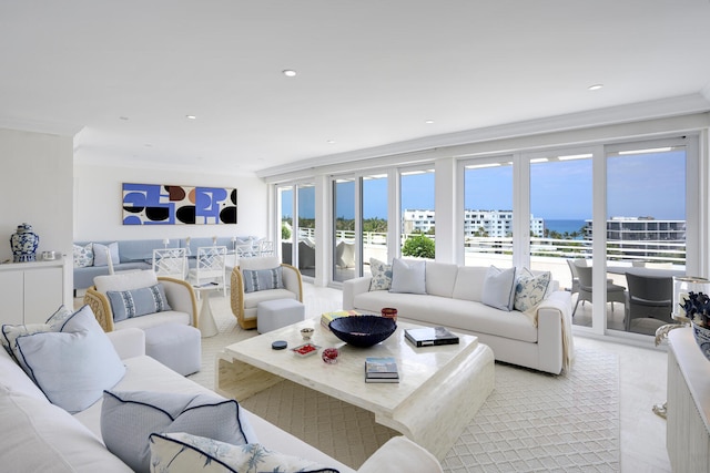 living room featuring crown molding and a water view