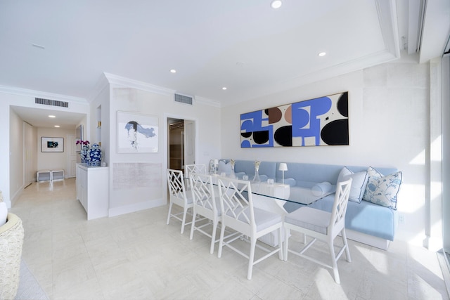 dining area featuring light tile flooring and ornamental molding