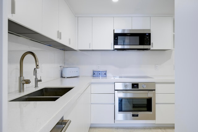 kitchen featuring white cabinets, sink, and stainless steel appliances