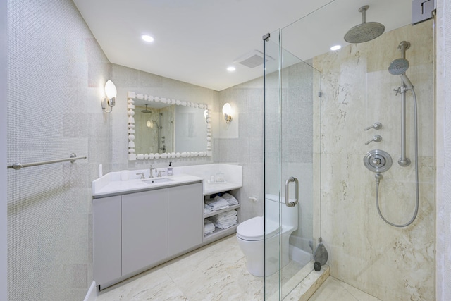 bathroom featuring a shower with shower door, toilet, oversized vanity, and tile floors