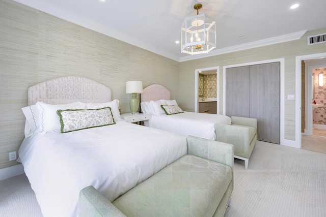 carpeted bedroom with a chandelier, ensuite bath, and crown molding